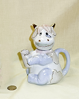 Light blue smiling cow caricature teapot