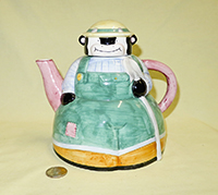 Cow farmer in green overalls teapot