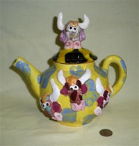 Homemade teapot with bull heads left