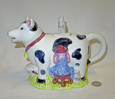 Happy Holstein being milked teapot