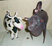 black and white cow and brown metal cow watering cans