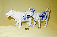 Two Delft cow creamers with raised rt leg