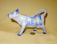 Blue Delft cow creamer by W.H. Sechler, left