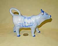 Blue Delft cow creamer by W.H. Sechler, right