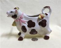 Black & white cow creamer with bee on butt