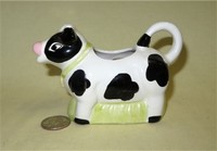 Black & white cow creamer with grass fill below belly