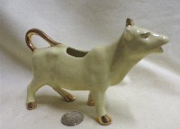 older cream colored cow creamer with gold trip