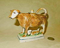 Brown spatter-painted cow creamer