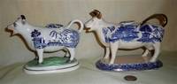 Two Blue Willow transfer printed cow creamers, left