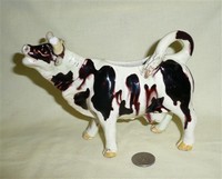 Old white and black cow creamer with no base