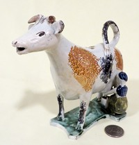 Cow creamer with 2 splatter marks and milkmaid