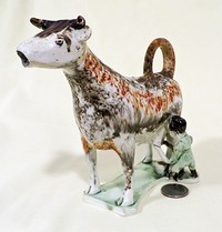 White & splatter painted Whieldon cow creamer with milkmaid