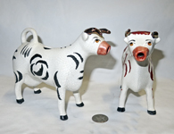 two very different Kent cow creamers