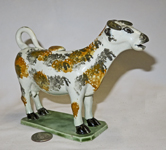 Multi-colored sponge painted dog faced cow creamer