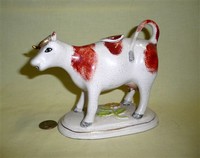 White cow creamer with brown spots and gold horns