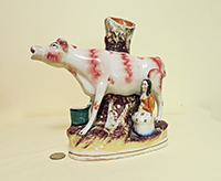 Large spill vase cow creamer with standing milkmaid