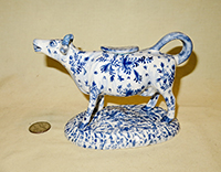 Long necked cow creamer with blue flowers, left