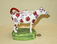 Purple nosed Swansea cow creamer on tall green base