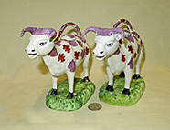Pair of Swansea Cambrian cow creamwers, side