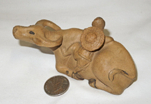 brown water buffalo, boy with hat & flute, top