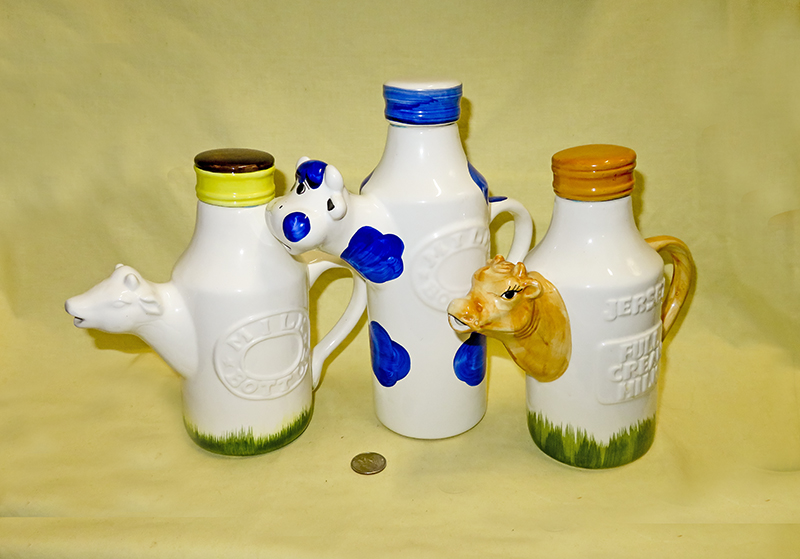 Three milk bottles with cow heads