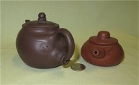 Two small Chinese yixing clay cow teapots