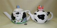 Teapots with cow head on front and on top