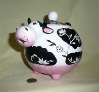Caricature black and white cow teapot with simple flowers