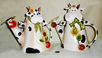 2 flowery cow watering cans